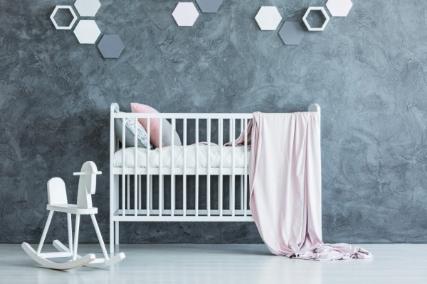 white baby crib in a grey nursery